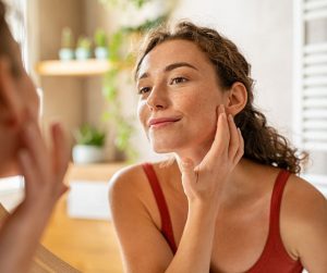 girl doing skincare in the mirror