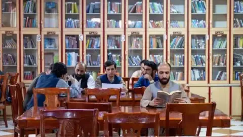 Afghanistan's rulers prohibit textbooks produced by women from the nation's universities
